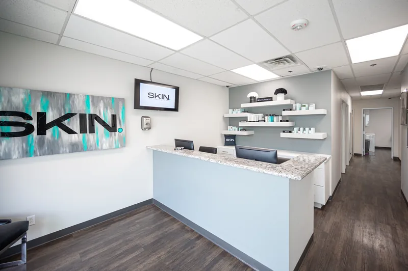 Front reception desk and SKIN wall art at SKIN Las Vegas med spa